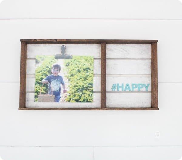 family photo hung in a farmhouse style as a decor with a happy written in text as a DIY projects