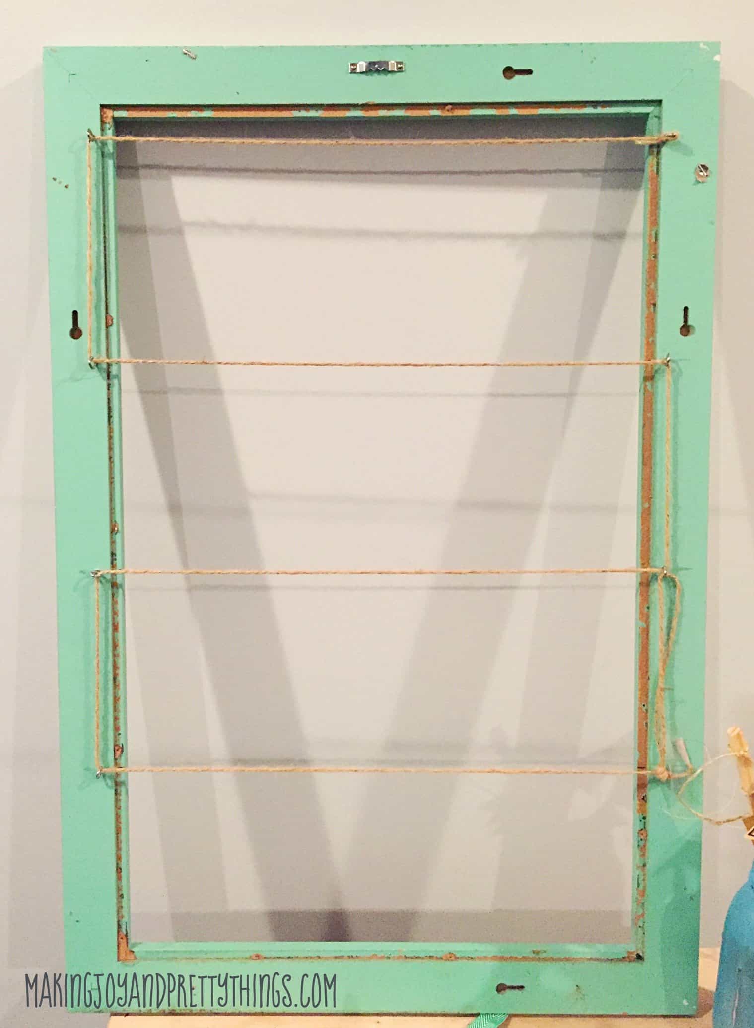 Fully stringed monthly photo frame with twine ready to hang monthly photos of your young one