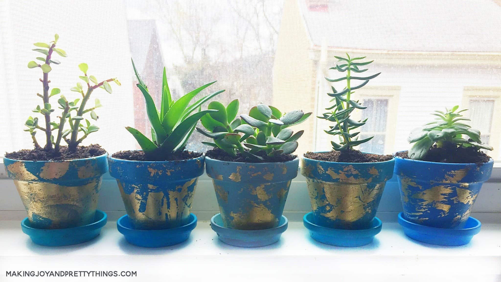 The possibilities are endless when making these diy gold leaf planters. Paint whatever color you want and apply the gold foil in a random fashion