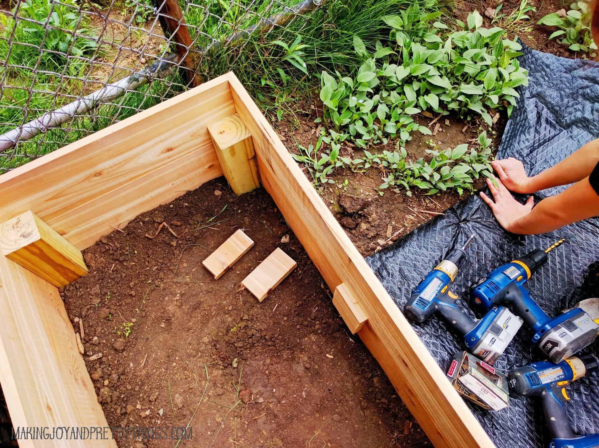 Long cedar plank runs need cedar support for the planting mix in a raised garden bed 