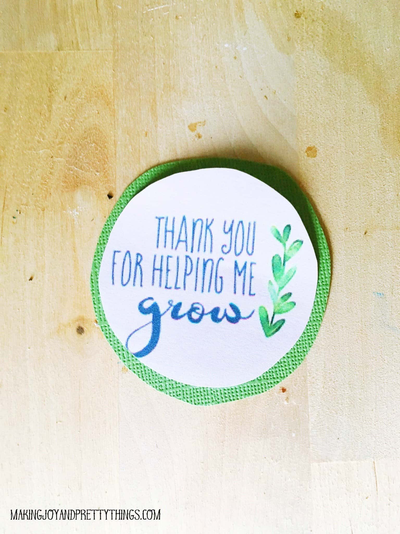 Finished product tag with thank you for helping me grow printable on top of cardstock ready for a hole punch