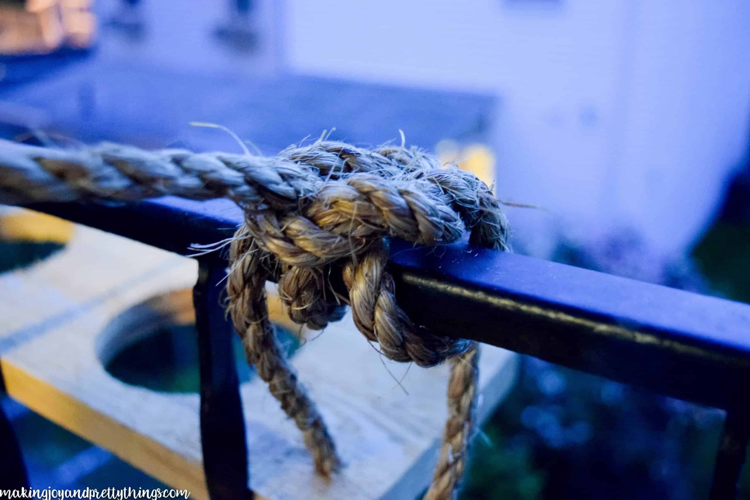 Tying a knot to a railing in a specific way to have a a secure attachment for plants