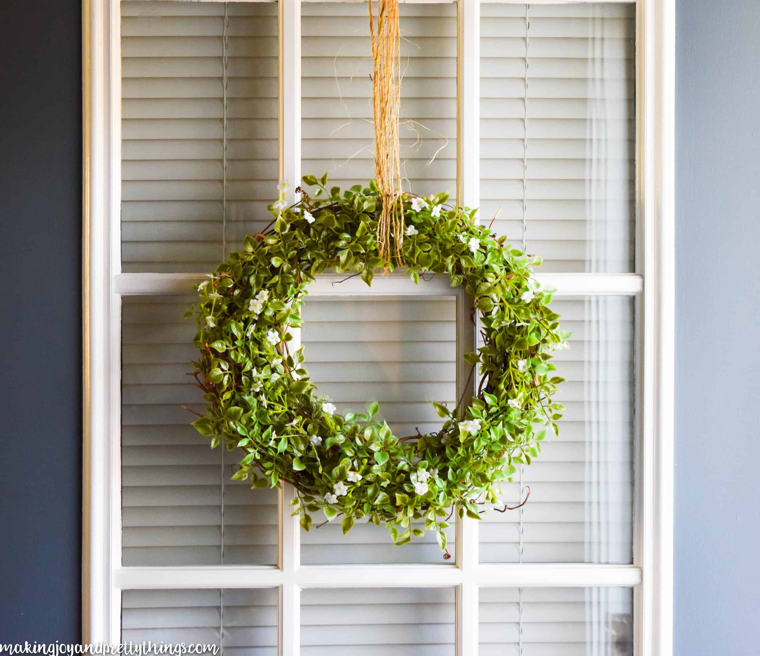 Classic farmhouse wreath hanging with jute twine on a front door