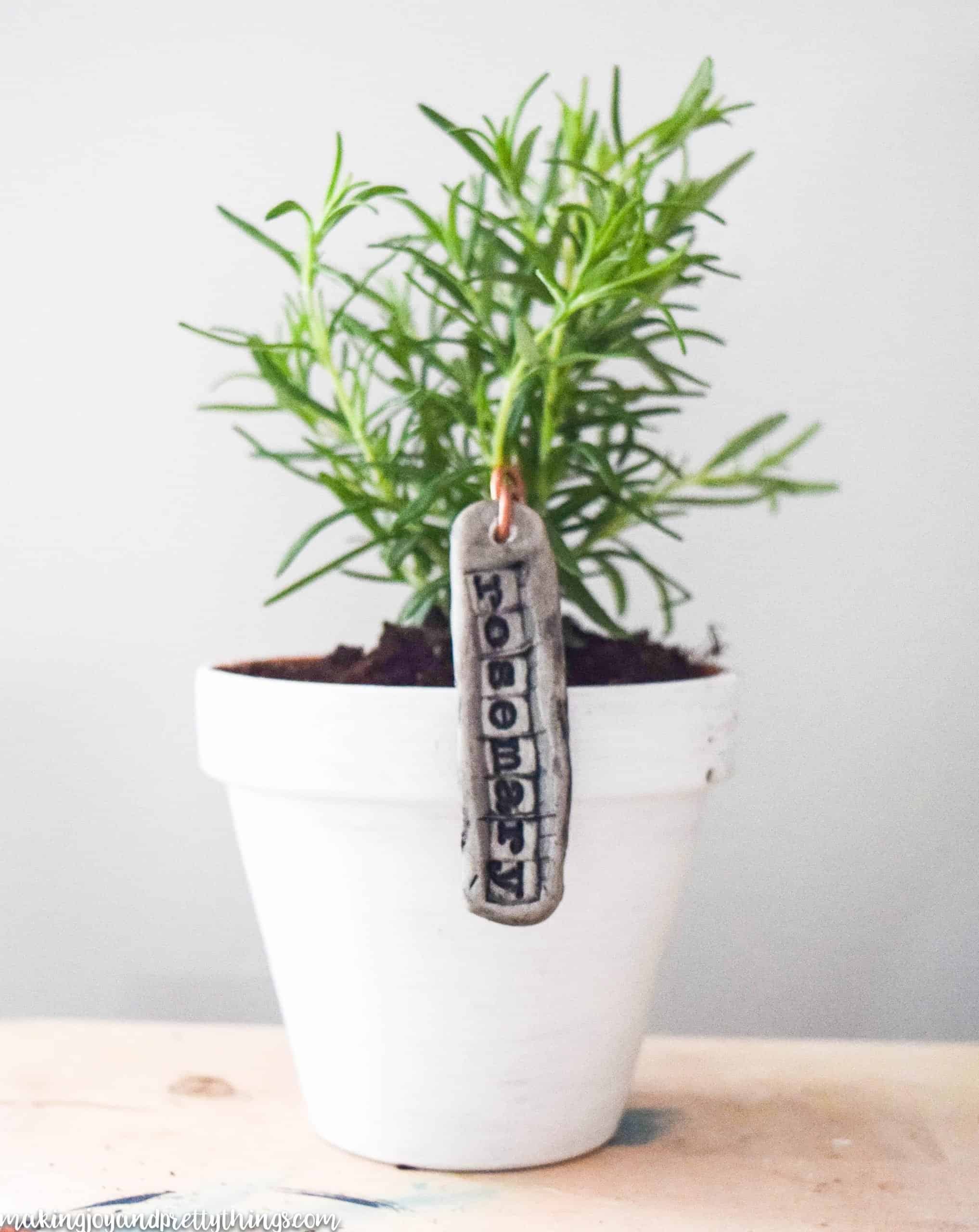 Distressed farmhouse pots are a great addition to these DIY plant labels and create an overall rustic look