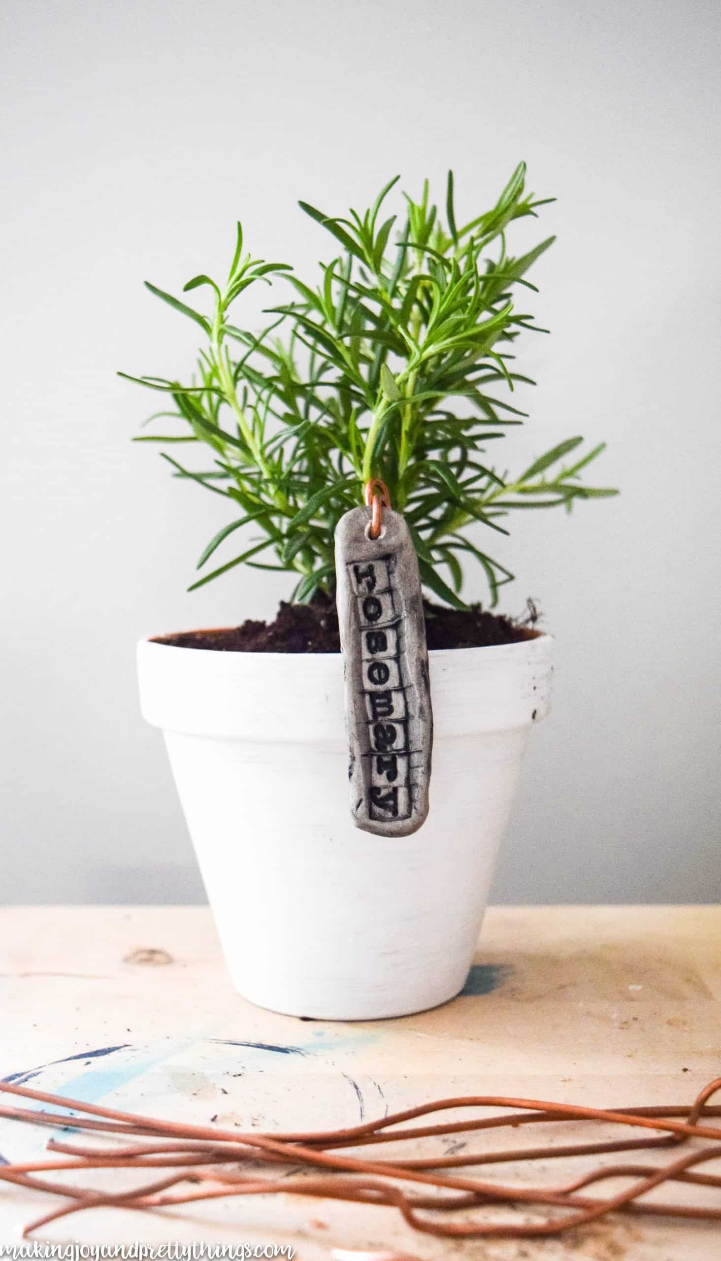 Copper wire laid down before a distressed pot with a garden marker in the potted plant