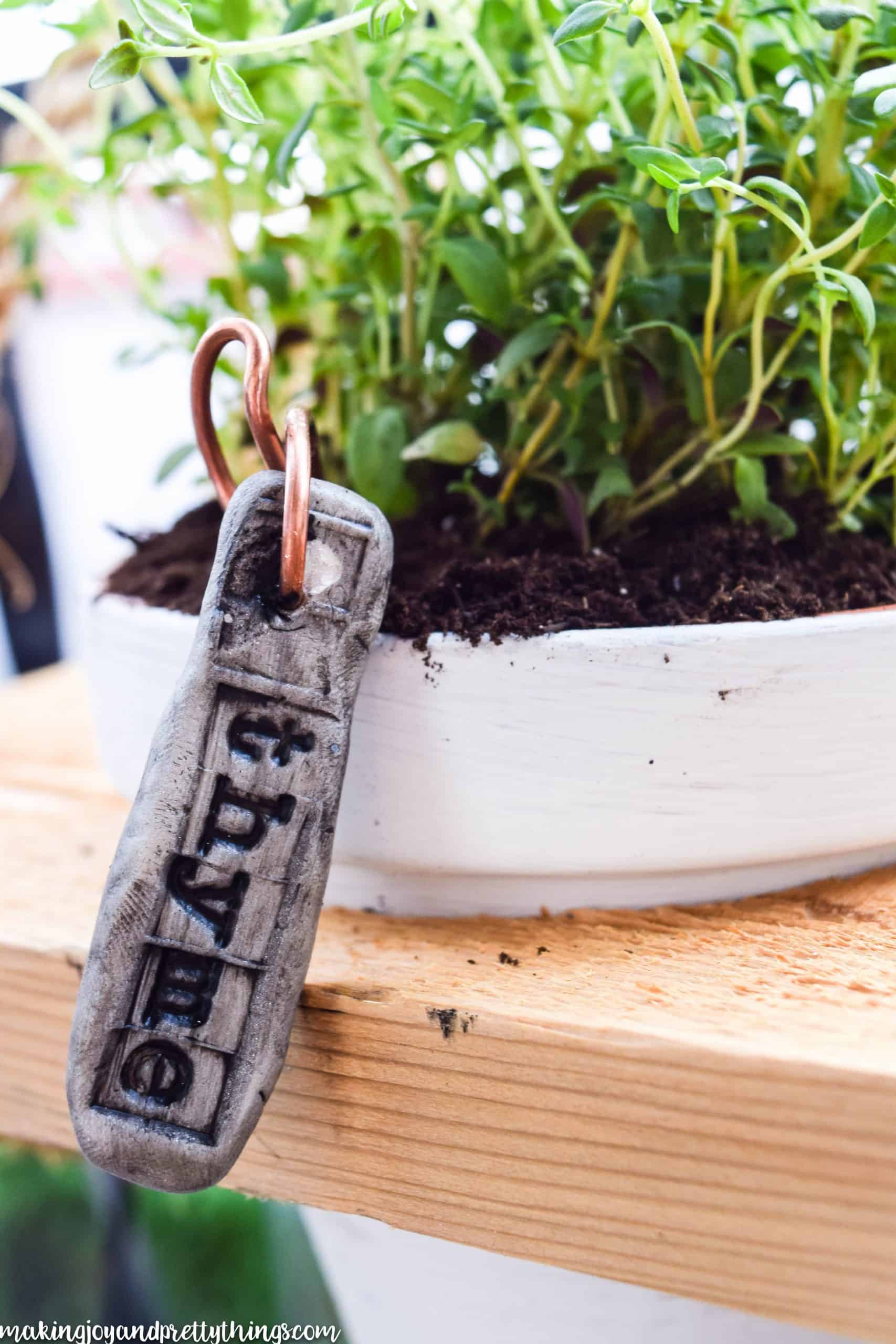 Tagging plants using clay and copper wire.  Really adds rustic and farmhouse charm to plants.  Easy DIY plant markers perfect for herb garden, container garden or vegetable garden. 