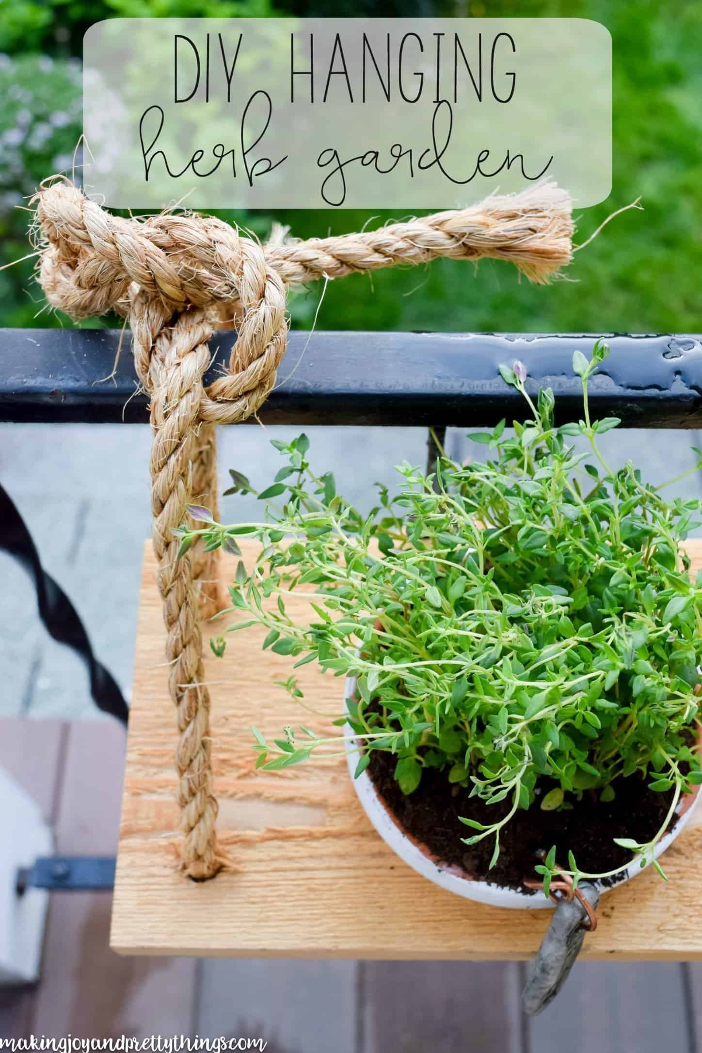 You HAVE to check out this amazing DIY hanging herb garden!! Perfect DIY herb garden for a small outdoor space. Hangs on a railing like a window box!