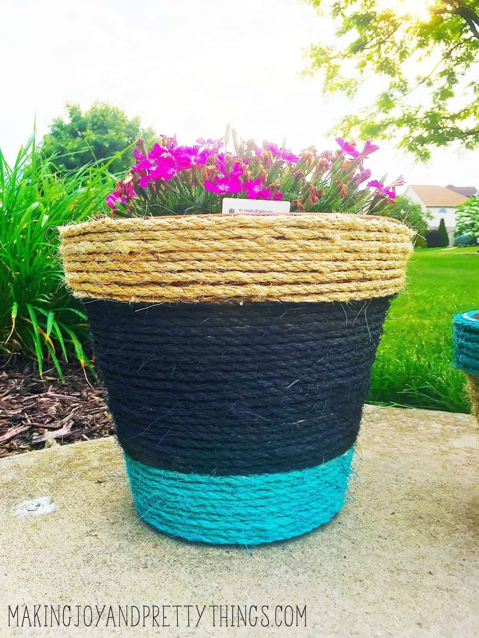 Rope wrapped and painted DIY planters. Perfect easy DIY to kick off summer. Can be customized with any color to compliment your garden area. Makes a great DIY gift.