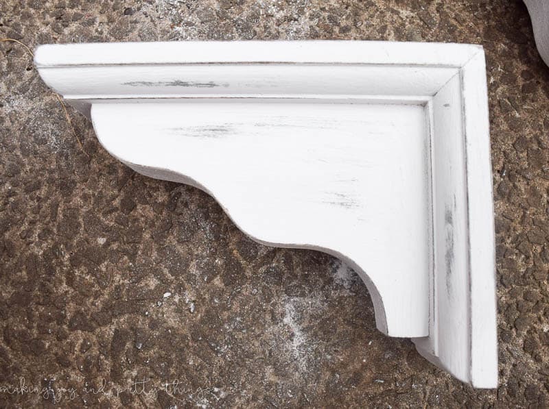Distress corbels with a little bit of sanding to give a unique old rustic feel without the cost