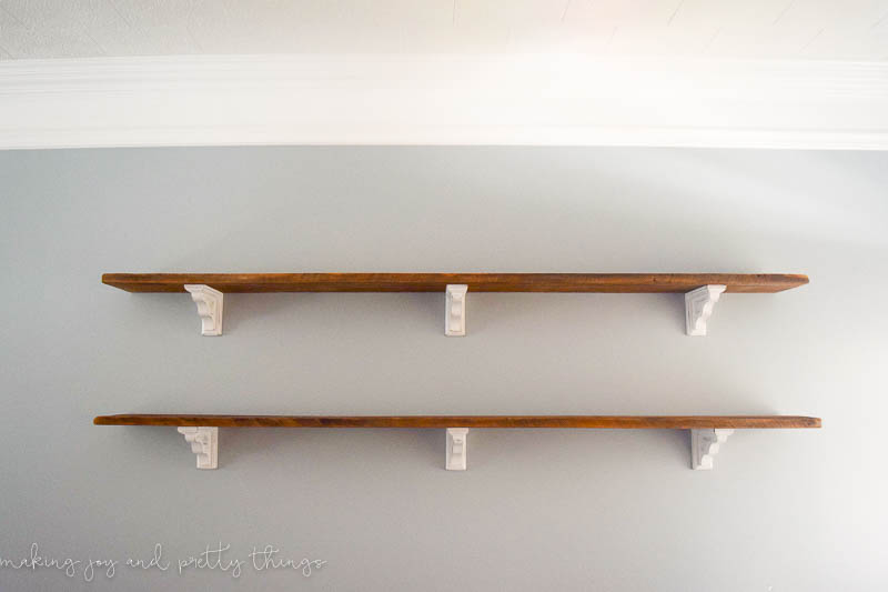 Finish DIY farmhouse shelves hanging in a room ready to be decorated providing much needed space for decor