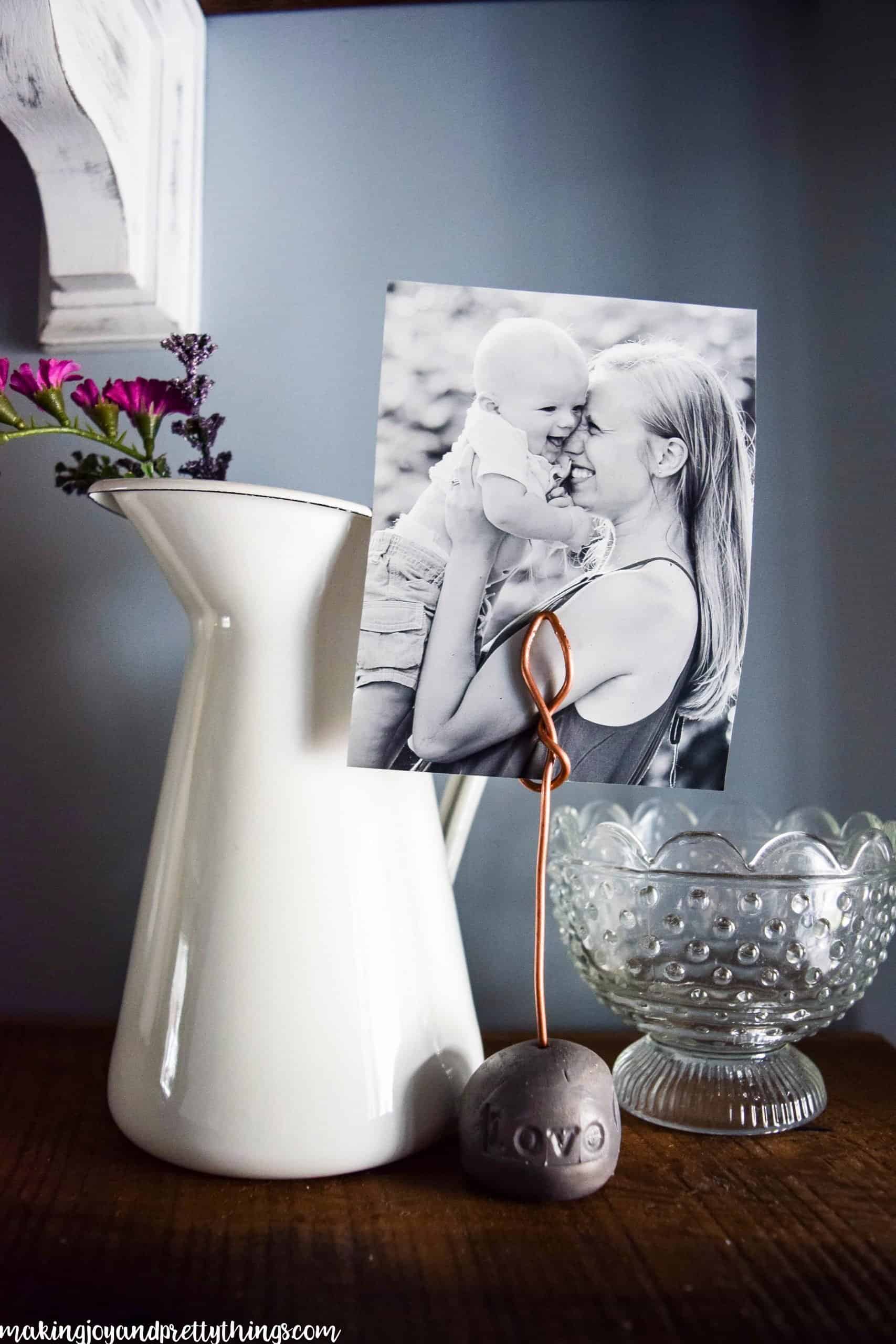 A photo of a mother and child displayed with flora touches and vintage dishes on rustic shelves