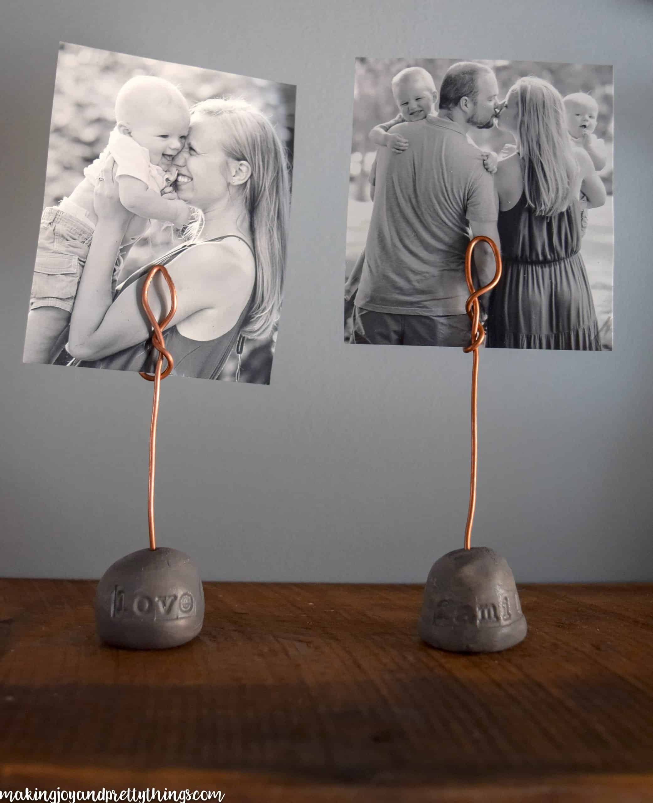 Showing off family photos with DIY wire photo holders displayed on a rustic wood shelf with farmhouse style