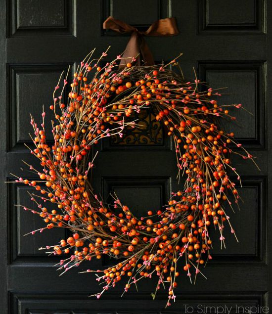 Berry fall wreath done in a farmhouse rustic way to hang on a front door for the fall season