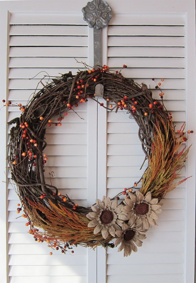 Beautiful DIY fall wreath with burlap flowers and fall grasses wrapped around the entire wreath 