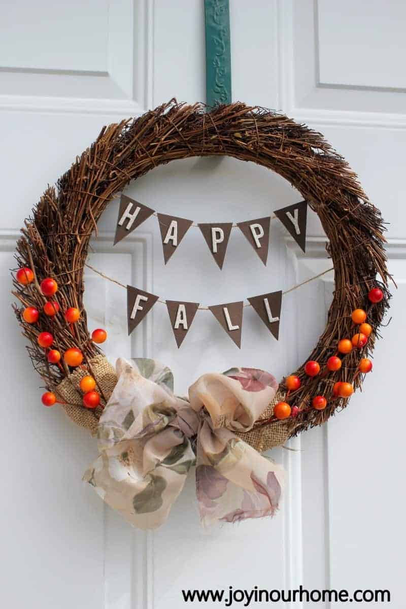 Hanging letters in a fall wreath and DIY'd with burlap and faux berries wrapped around twigs