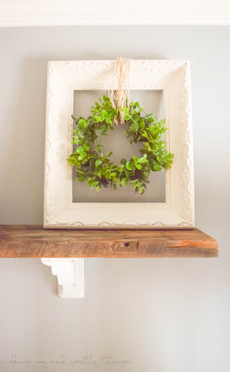 Simple Farmhouse Decor: Upcycled frame + wreath! Easy fixer upper and farmhouse style DIY that is budget friendly using an old frame. Add a fresh green wreath and it's a perfect farmhouse-inspired DIY