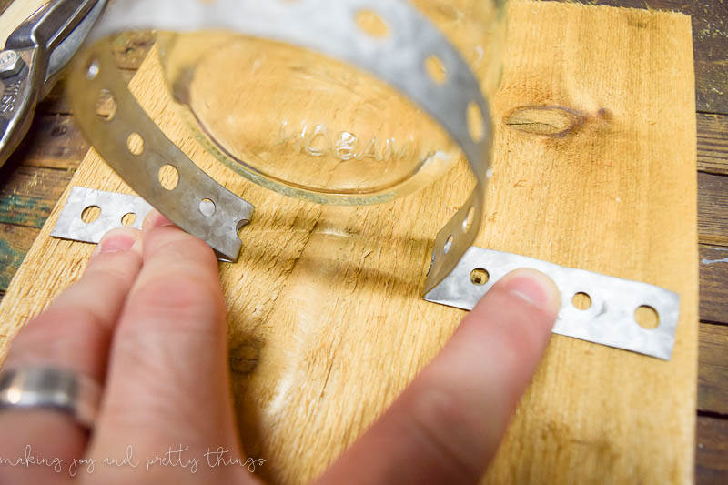 Predrilled cedar wood plank to attach mason jar strap to get ready to hang on the wall