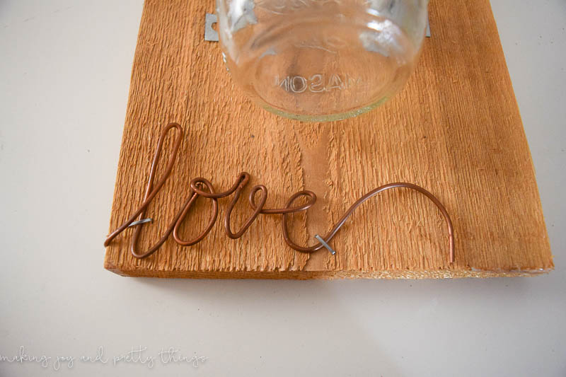 Copper wire used as a trace to make a word adds a unique rustic look on this cedar plank