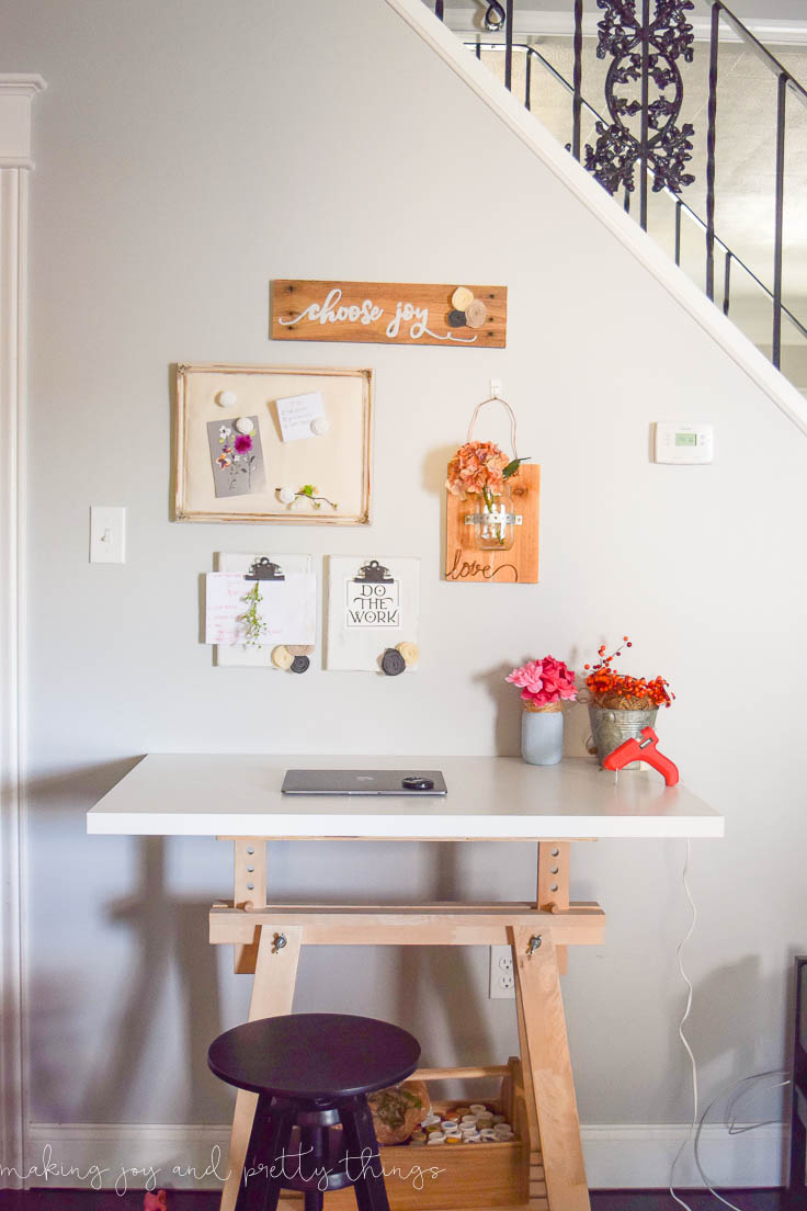 Completed gallery wall with organizational decor for an office space with a Hanging mason jars on wood DIY