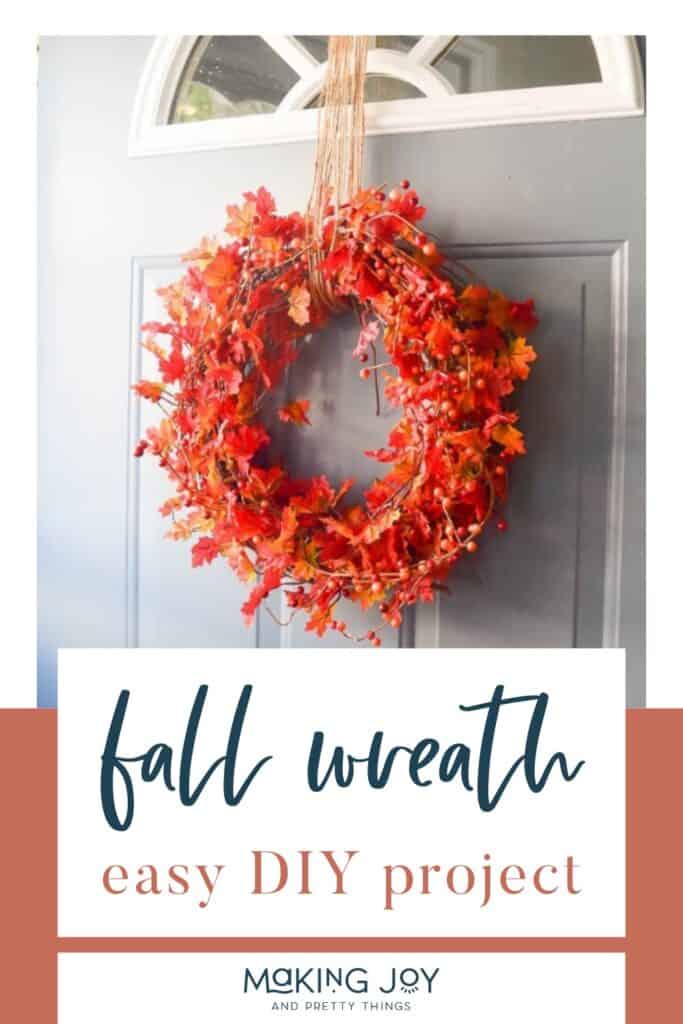 Photo of an orange wreath hanging on a door with text overlay that reads 'Fall Wreath Easy DIY Project.
