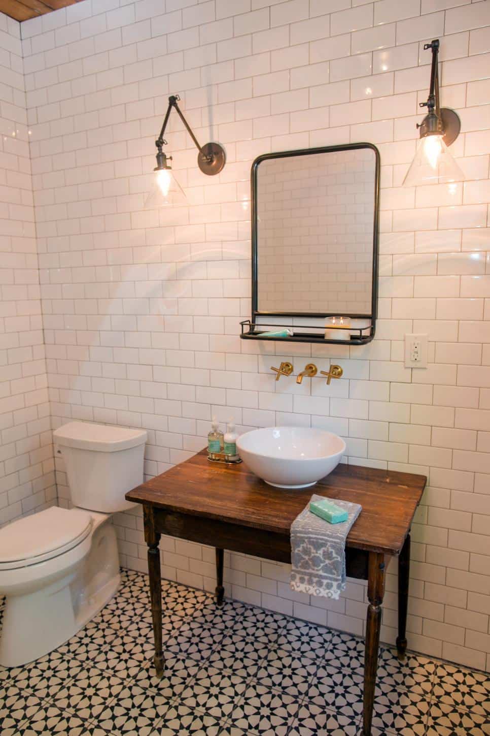 I love this timeless classic pattern of the star shape on this black and white cement tile floor in the bathroom with subway tile walls featured by HGTV by Fixer Upper (Chip and Joanna Gaines)