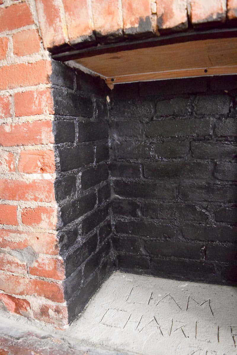 A closer look at the inside of our natural brick fireplace, which we painted black, and leveled out with quick-set concrete.