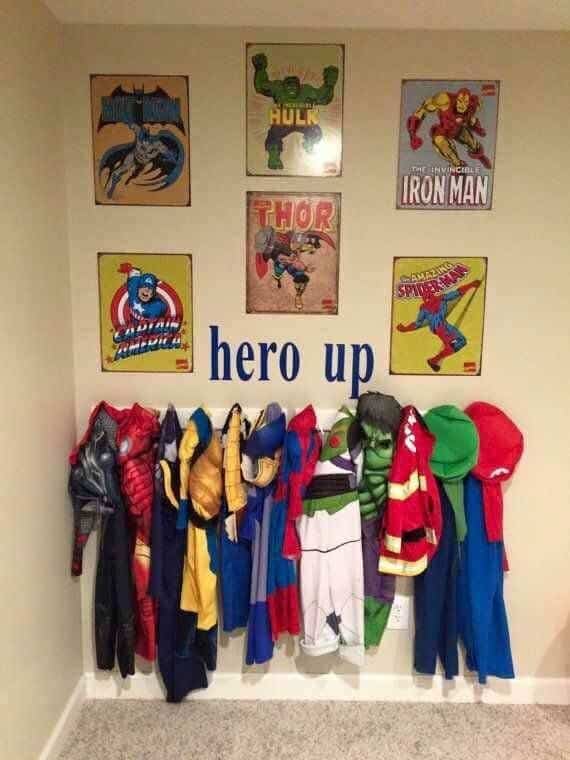 A cute way to organize costumes for a share kids bedroom by hanging up costumes and pictures on a wall
