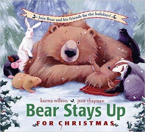 Bear Stays Up For Christmas by Karma Wilson celebrates the holidays with Bear and his friends in this sweet picture book. Bear’s friends are determined to keep Bear awake for Christmas! So they wake Bear up and have him help them find a Christmas tree, bake cakes, hang up stockings, and sing Christmas songs. Bear stays up—by discovering that giving is one of the best Christmas presents of all!
