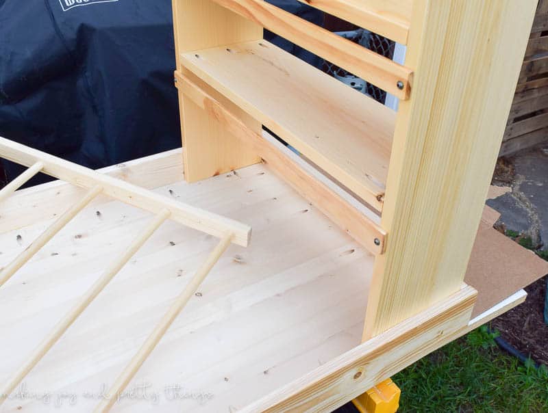 Building a book holder for the kids craft table. Two wooden shelves and a ladder-like rack will be attached to the side of the craft table.