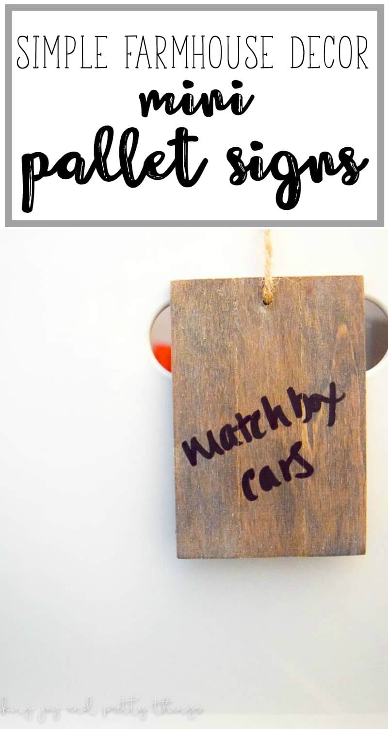 A small piece of wood being used as a DIY basket label with handwritten words "matchbox cars" hangs from a storage box. Image text reads "simple farmhouse decor. Mini pallet signs"