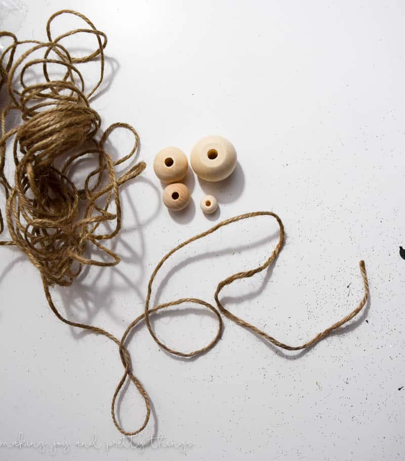 Using various sized wood beads and twine are a great way to make a DIY wood bead garland