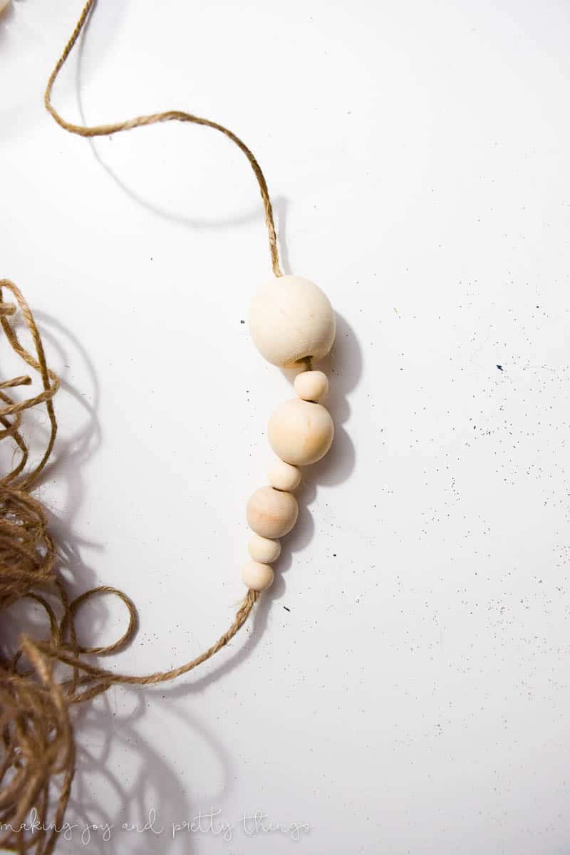 Use wooden beads to string onto twine to make Christmas decorations to add some DIY charm