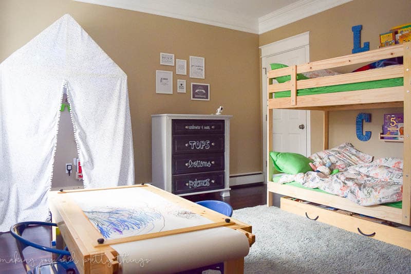Another photo of the Shared Boys Bedroom, with a kids craft table, kids' reading nook, and bunk bed.