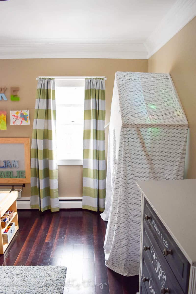 Shared Boys Bedroom packed with tons of storage and organization ideas, a kids craft table, kids reading nook, bunk beds, DIY magnet board, clothing storage and fun, bright and modern design!