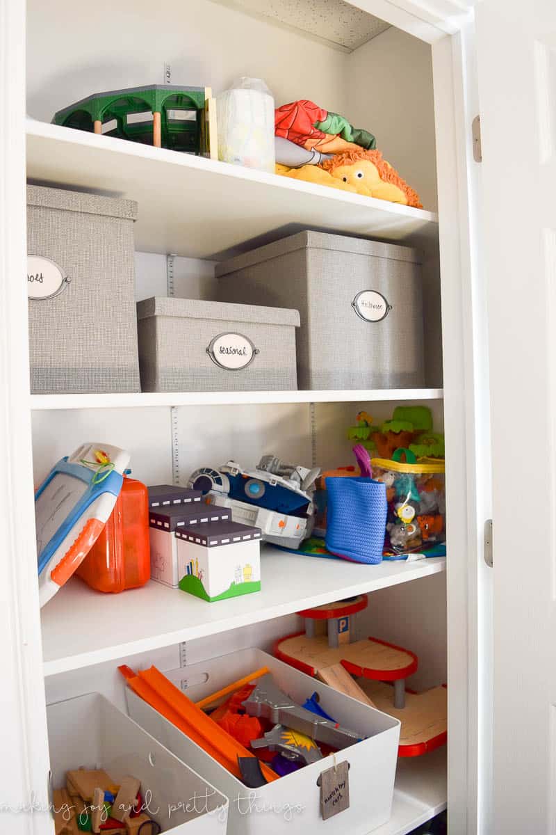 A photo of the third and fourth shelves, which are organized with bins. 