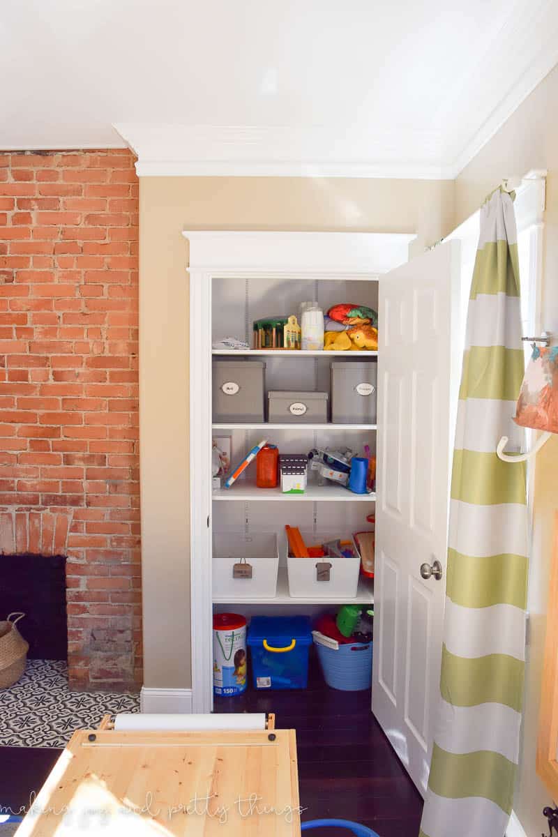 Shared Boys Bedroom packed with tons of storage and organization ideas, a kids craft table, kids reading nook, bunk beds, DIY magnet board, clothing storage and fun, bright and modern design!