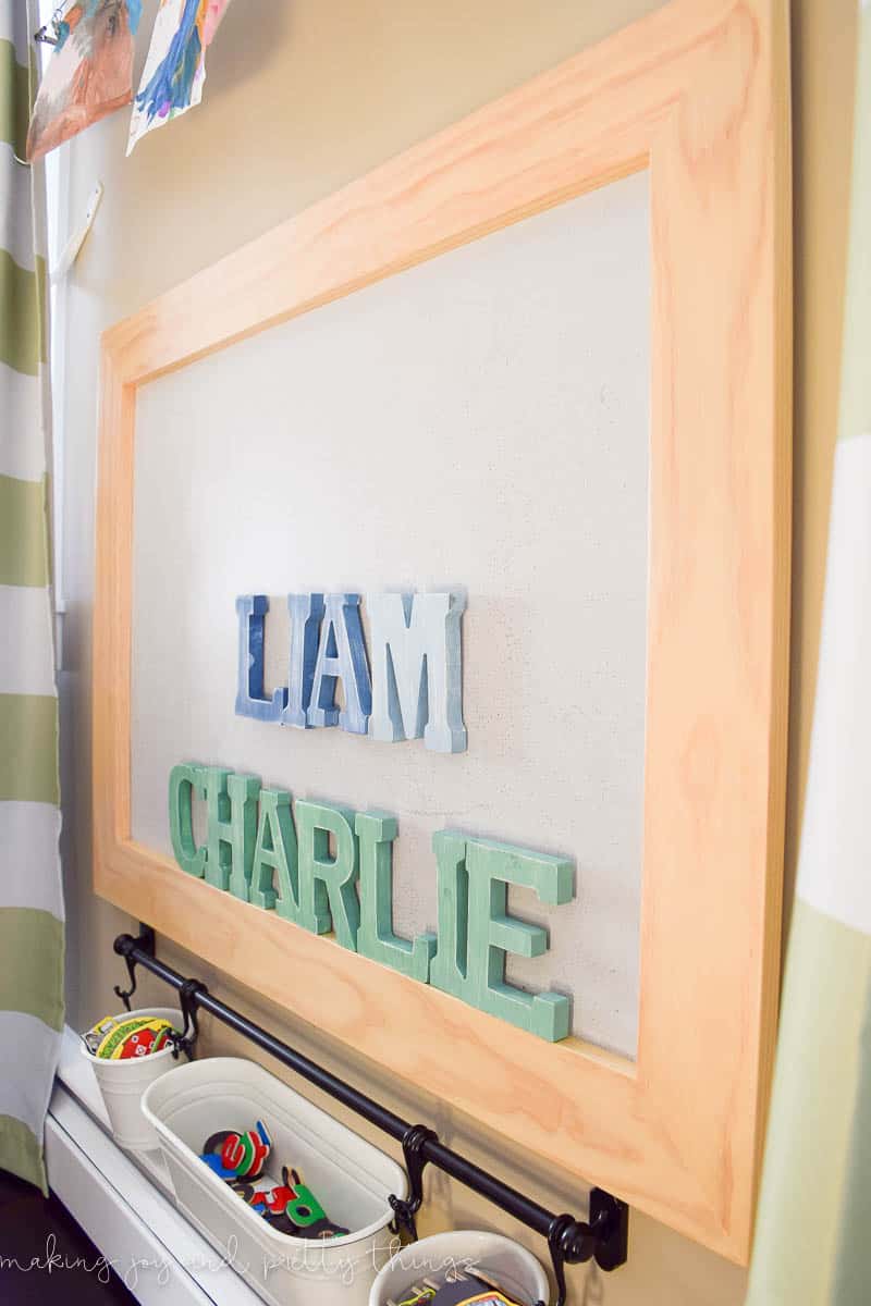 A photo of ombre distressed magnet letters for each little boy and a magnetic board.