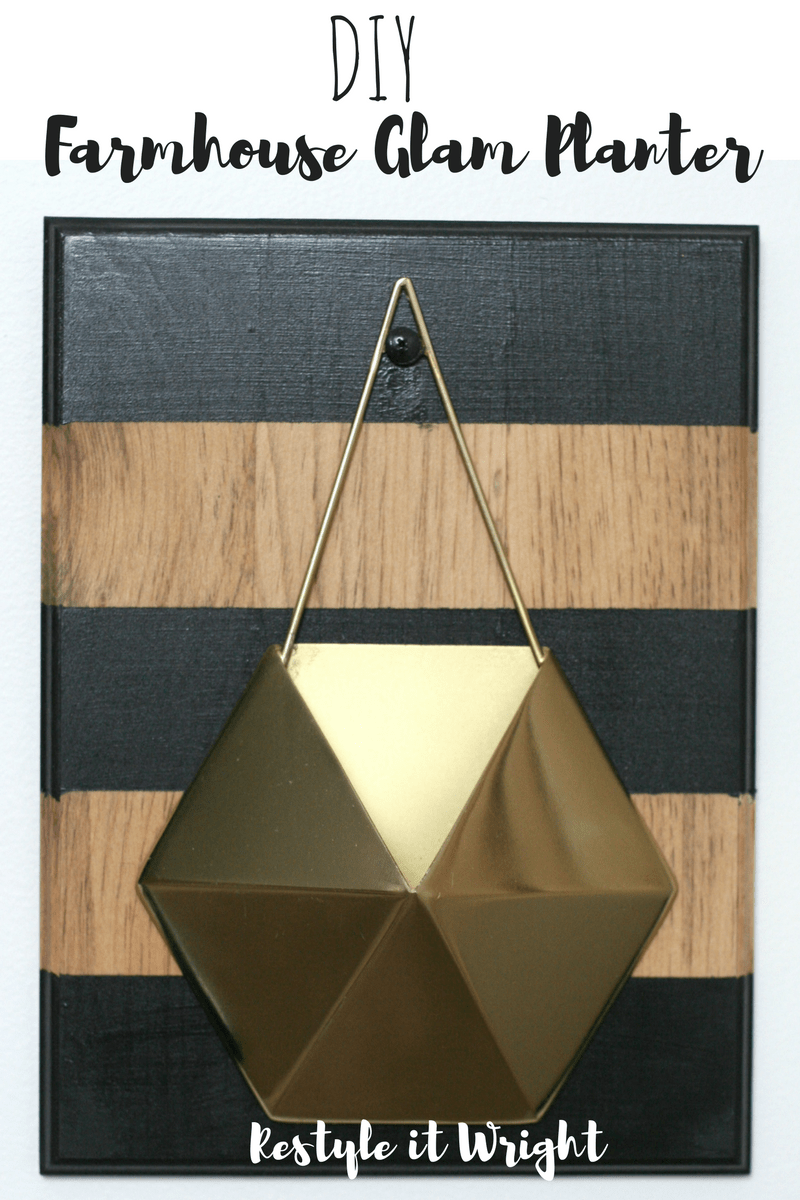 A geometric gold planter hangs on a wood plank, painted with three black stripes. Image overlay text reads "DIY farmhouse glam planter"