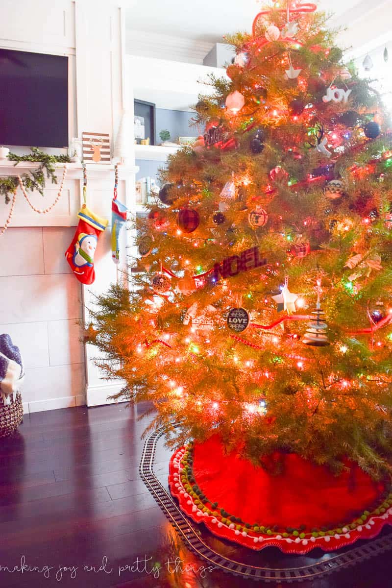 Our fully decorated Christmas tree, brightly lit with red and green Christmas lights, beaded garland, and a variety of colorful Christmas ornaments.