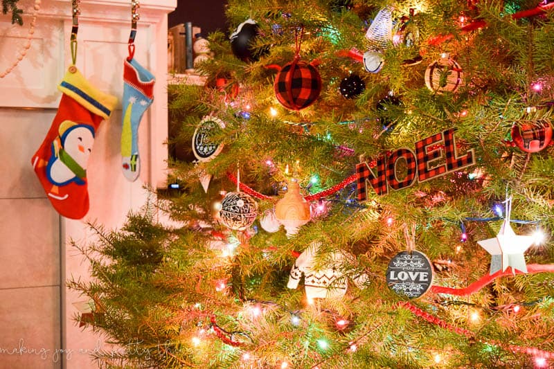 Our family Christmas tree, decorated with sparkling red and green Christmas lights, beaded garland, and a variety of red, white, and black Christmas ornaments. The soft glow of the Christmas lights fills the room.