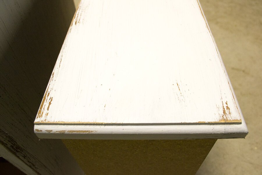 A drawer that has been painted with chalk paint and then sanded giving it a distressed look 