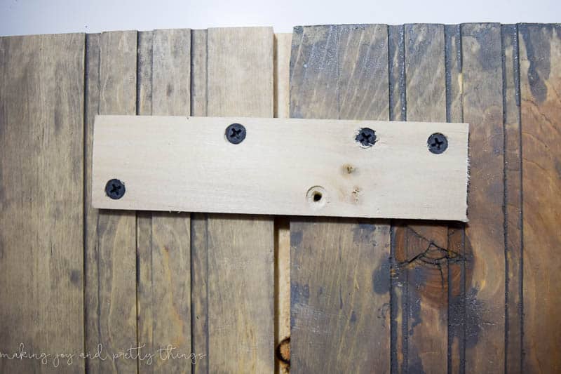 Screwing the two ghost wood shiplap pieces together for the DIY Christmas Card holder to make a better space for cards
