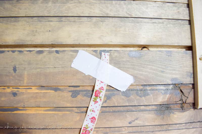 Secure your ribbon to the back of your holder using tape or any method then start wrapping the ribbon around your DIY Christmas card holder