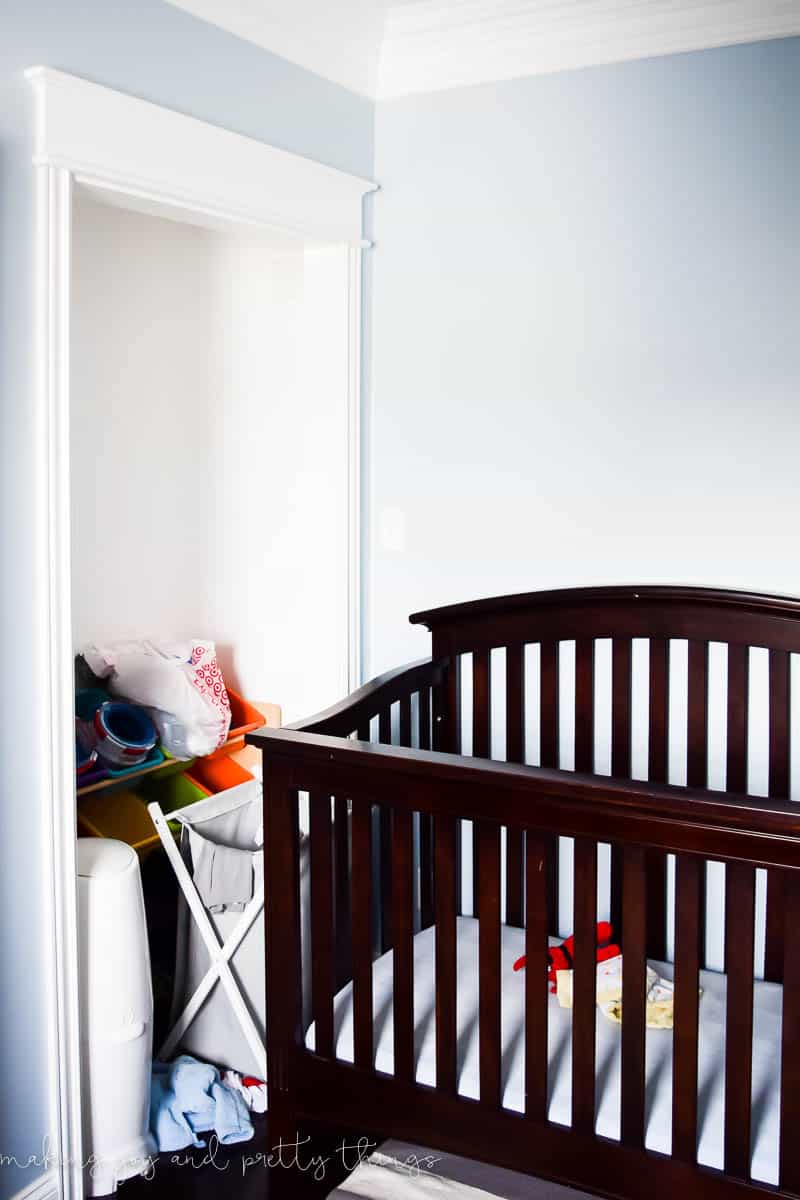 Before photo of a brown crib straight from a store in a kids nursery before a big renovation 