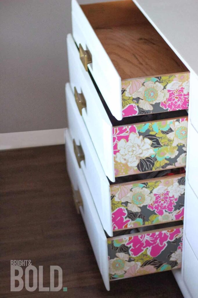 Using wallpaper on furniture and drawer slides is a great way to update an old piece