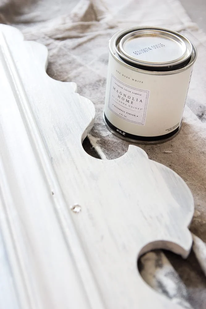 One Horn White from Magnolia, a creamy white paint color, is painted on this antique mirror frame to update it