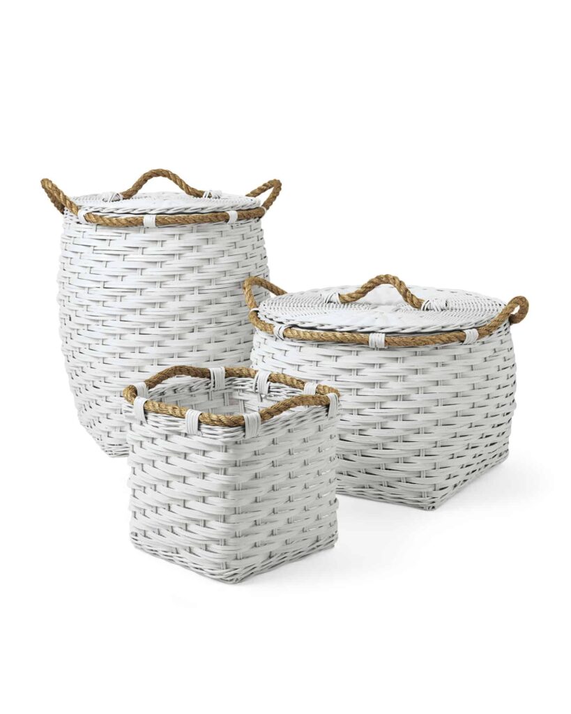 A set of three white woven rope baskets, each a different size. One is tall and cylindrical, a second is shorter and square with an oval lid, and the third is a shirt cube basket.