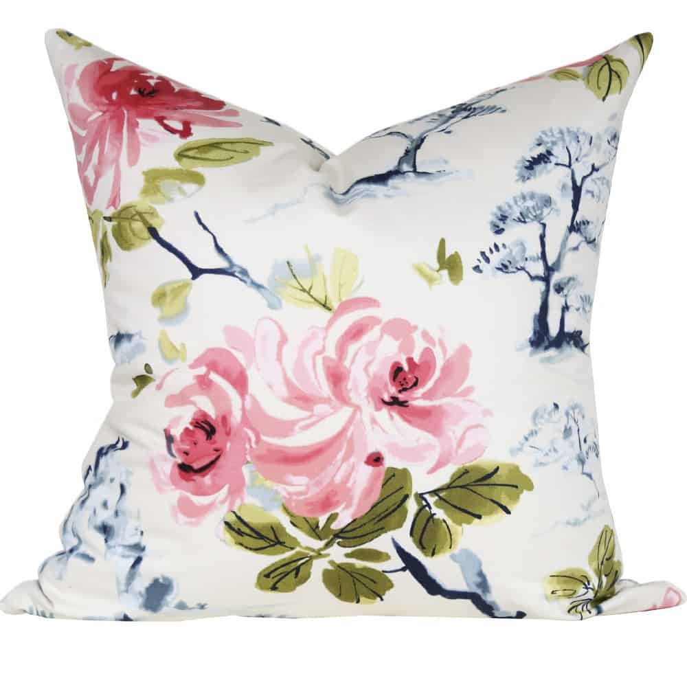 A throw pillow cover with pink, green, and blue flower pattern.