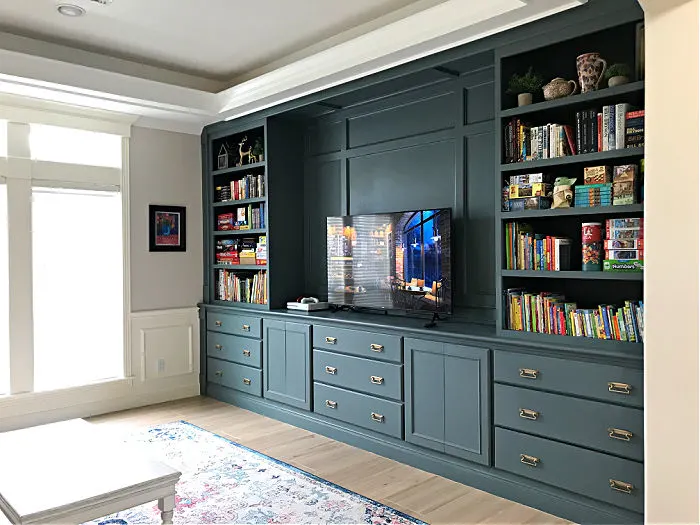 Duke Gray looks great on these living room built-in cabinets with book shelves, drawers and a place for the TV as an accent wall and a focal point of the room