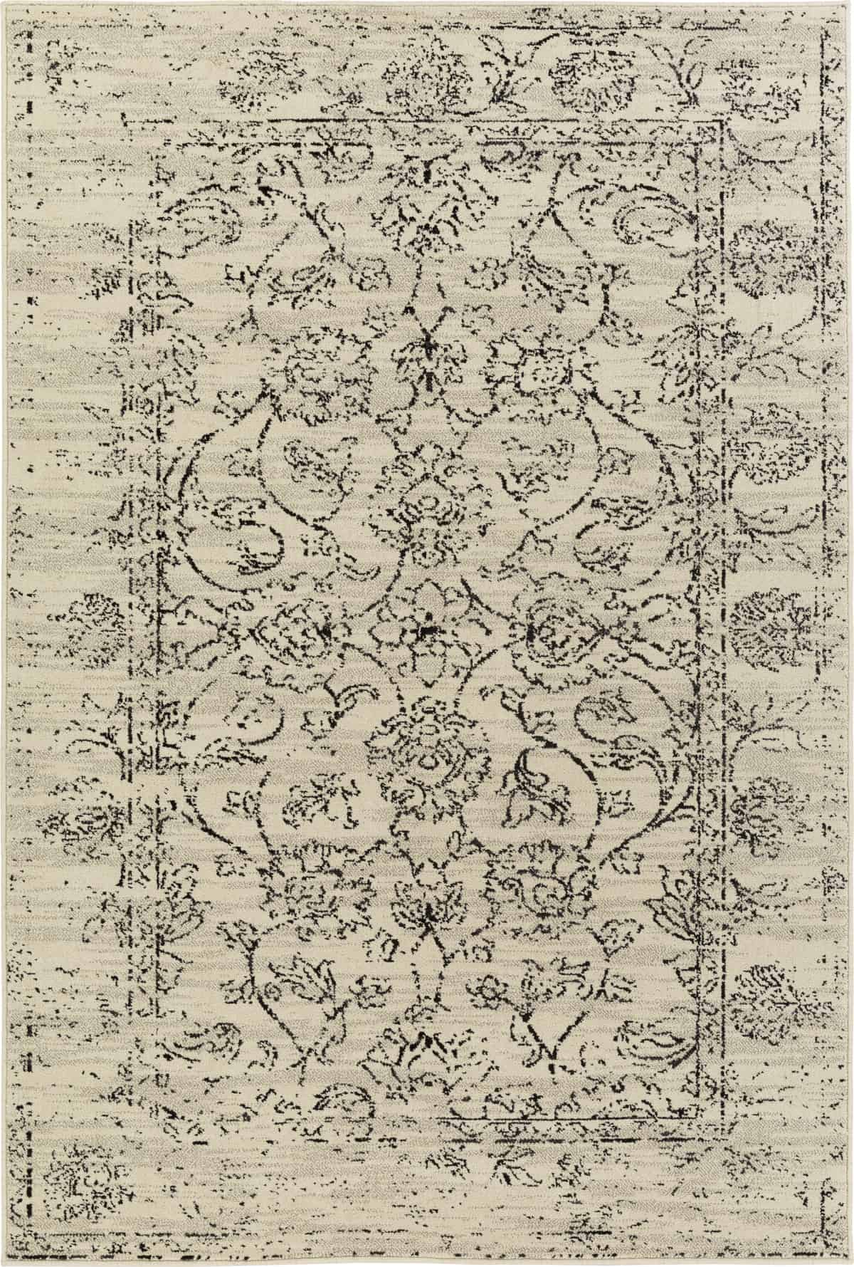 An ornate vintage tan and black area rug with detailed floral design.